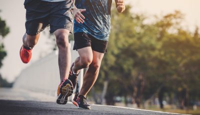 young people runner running on running road in city park